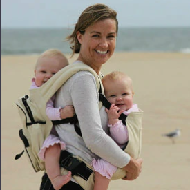 Mother carrying two babies with Moby Wrap