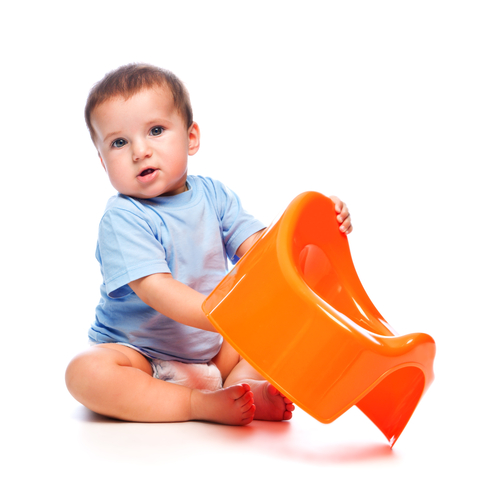 Child holding potty seat