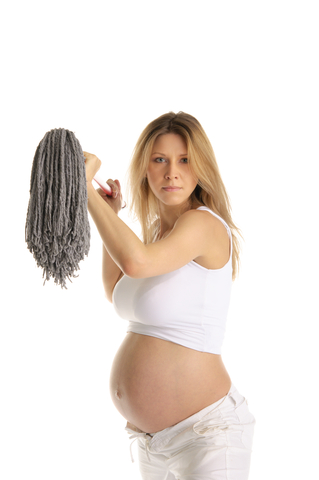 Annoyed pregnant woman with mop