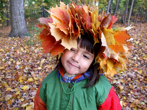 Child wearing fall leaf wreath