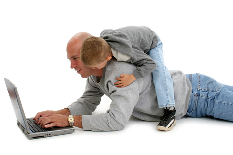 Dad with child at laptop